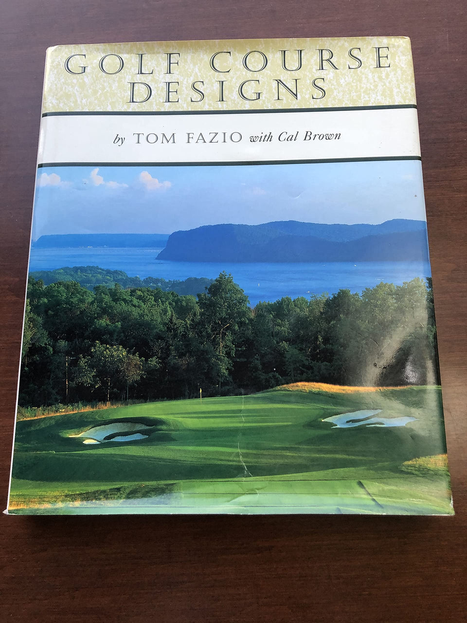 Abrams Books Golf Course Designs cover highlighting lush greens for design inspiration.