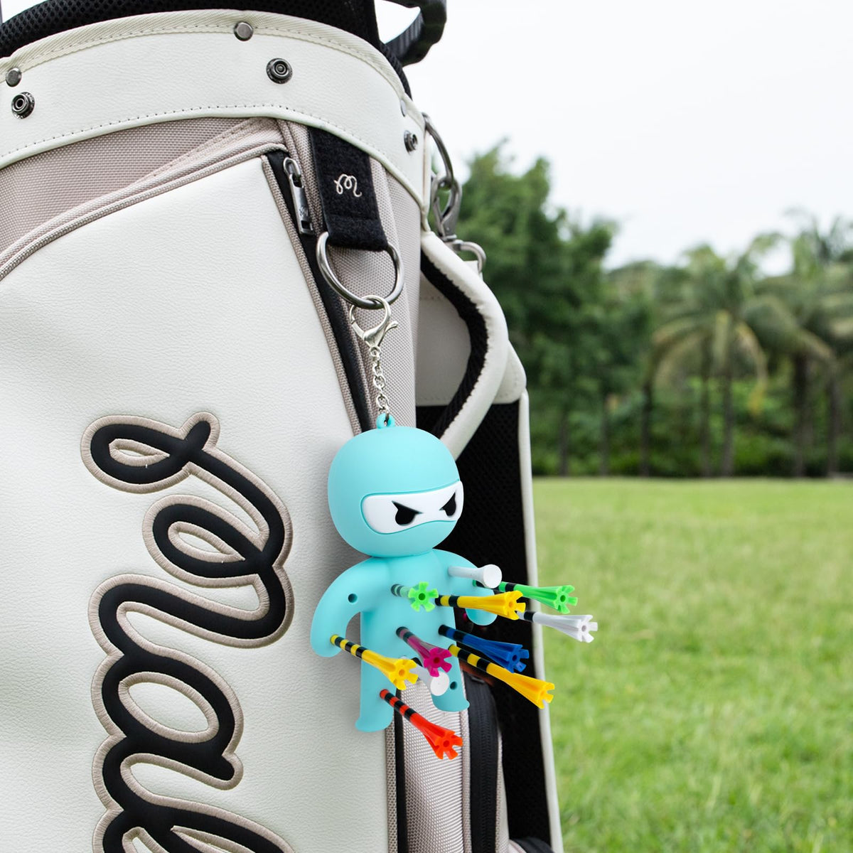 Aliennana keychain-tee-holder image demonstrates portability and bag attachment.