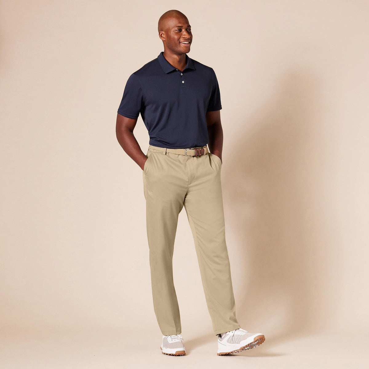 Amazon Essentials golf pant on model in outdoor setting.