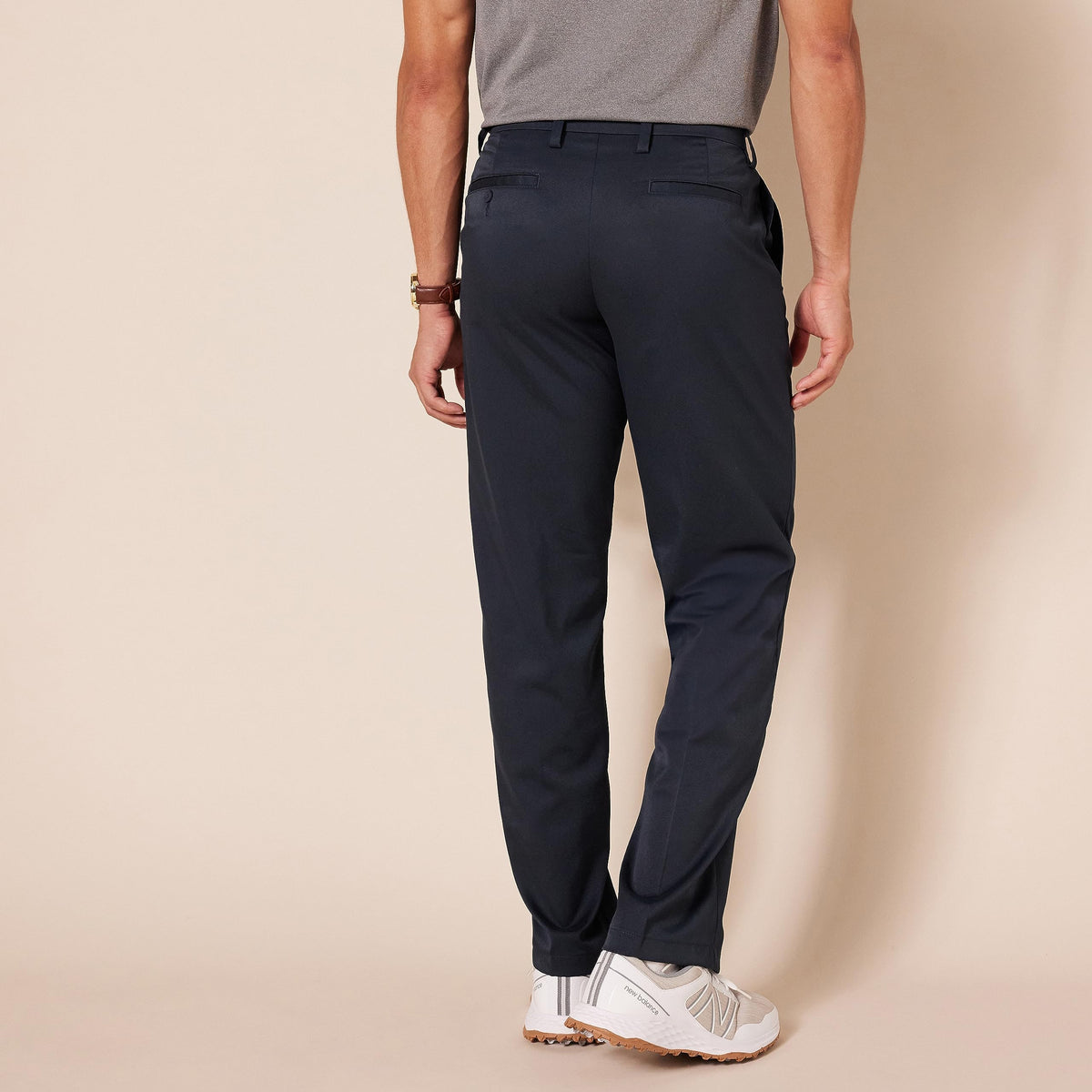 Amazon Essentials men's stretch golf pants navy side view highlighting flexible movement.