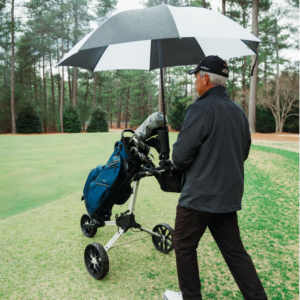 Bag Boy umbrella holder close-up clamp securing cart tubing during movement