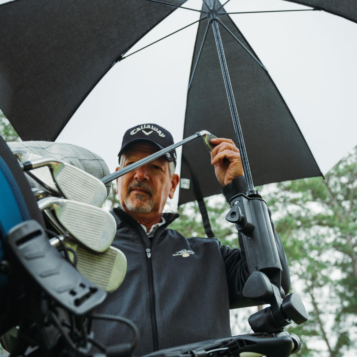 Bag Boy umbrella holder with umbrella securely inserted on cart for quick setup