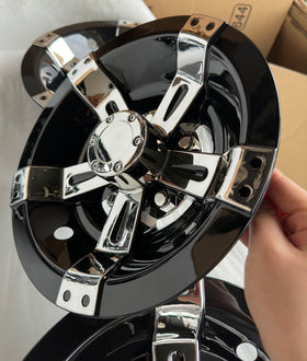 Set of four chrome-spoked wheel covers, securely packaged for gifting or storage.