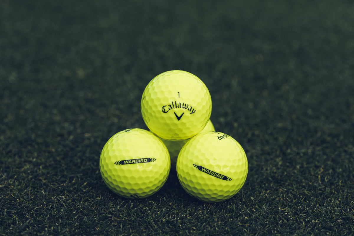 Callaway Warbird yellow ball arranged on tee for easy alignment and visibility.