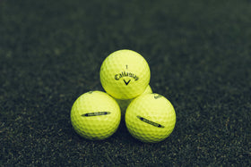 Callaway Warbird yellow ball arranged on tee for easy alignment and visibility.