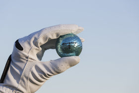 Chromax Metallic M5 purple golf ball aids quick tracking in grass.