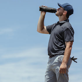 Clicgear red bottle carried on push cart for on-course hydration