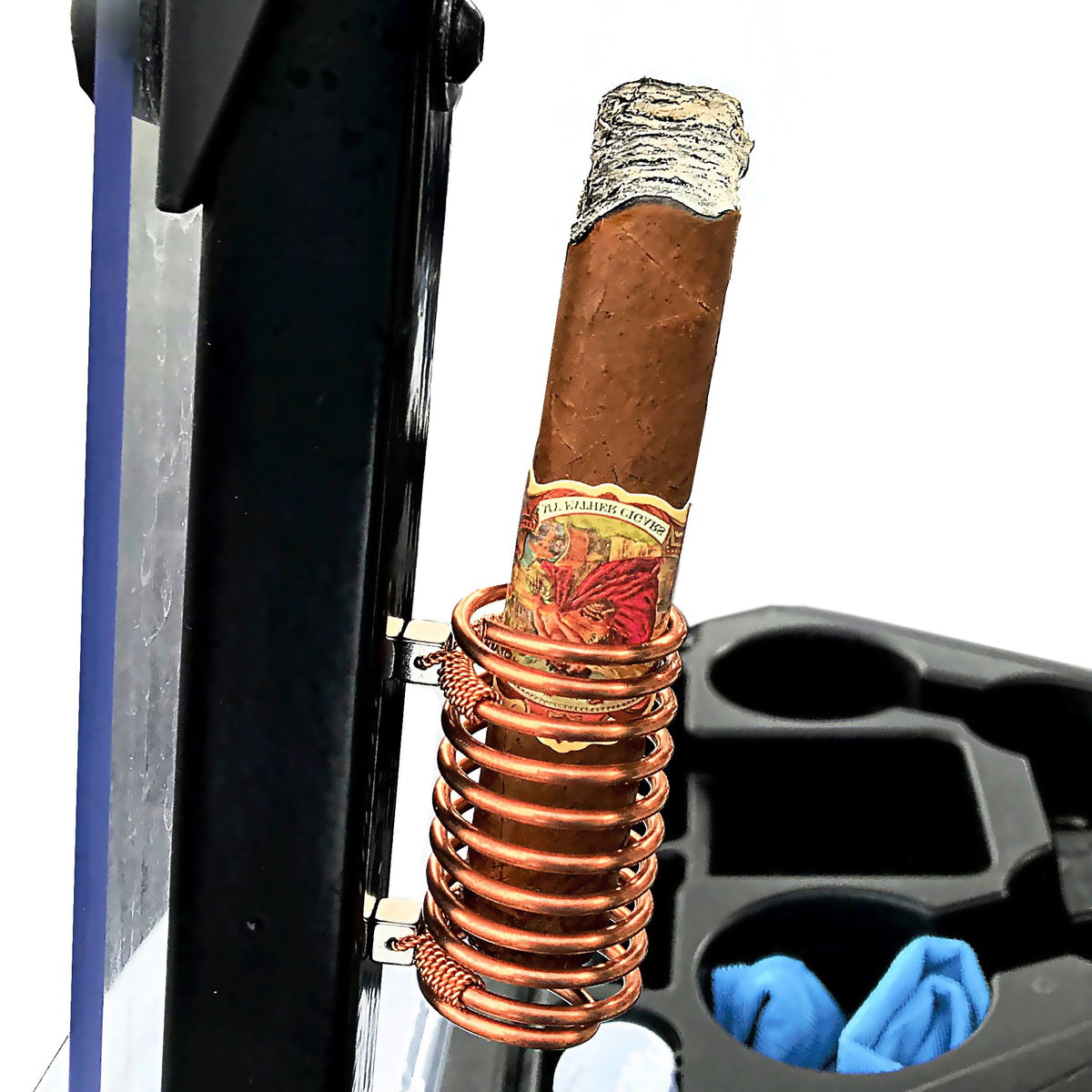 Copper Cigar Caddy attached to a golf cart magnet securely holding cigars on the move