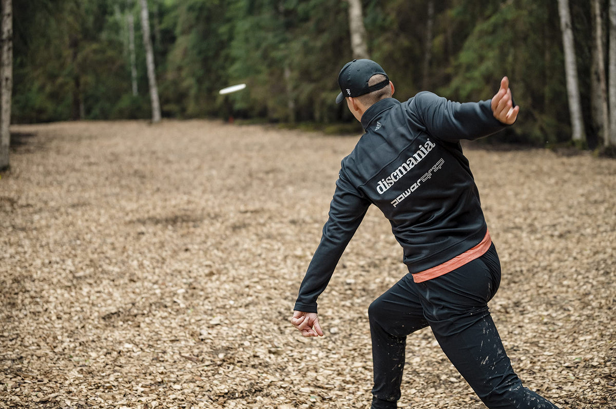 Discmania Origin midrange on wooded fairway, versatile control in tight spaces.