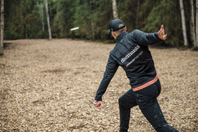 Discmania Origin midrange on wooded fairway, versatile control in tight spaces.
