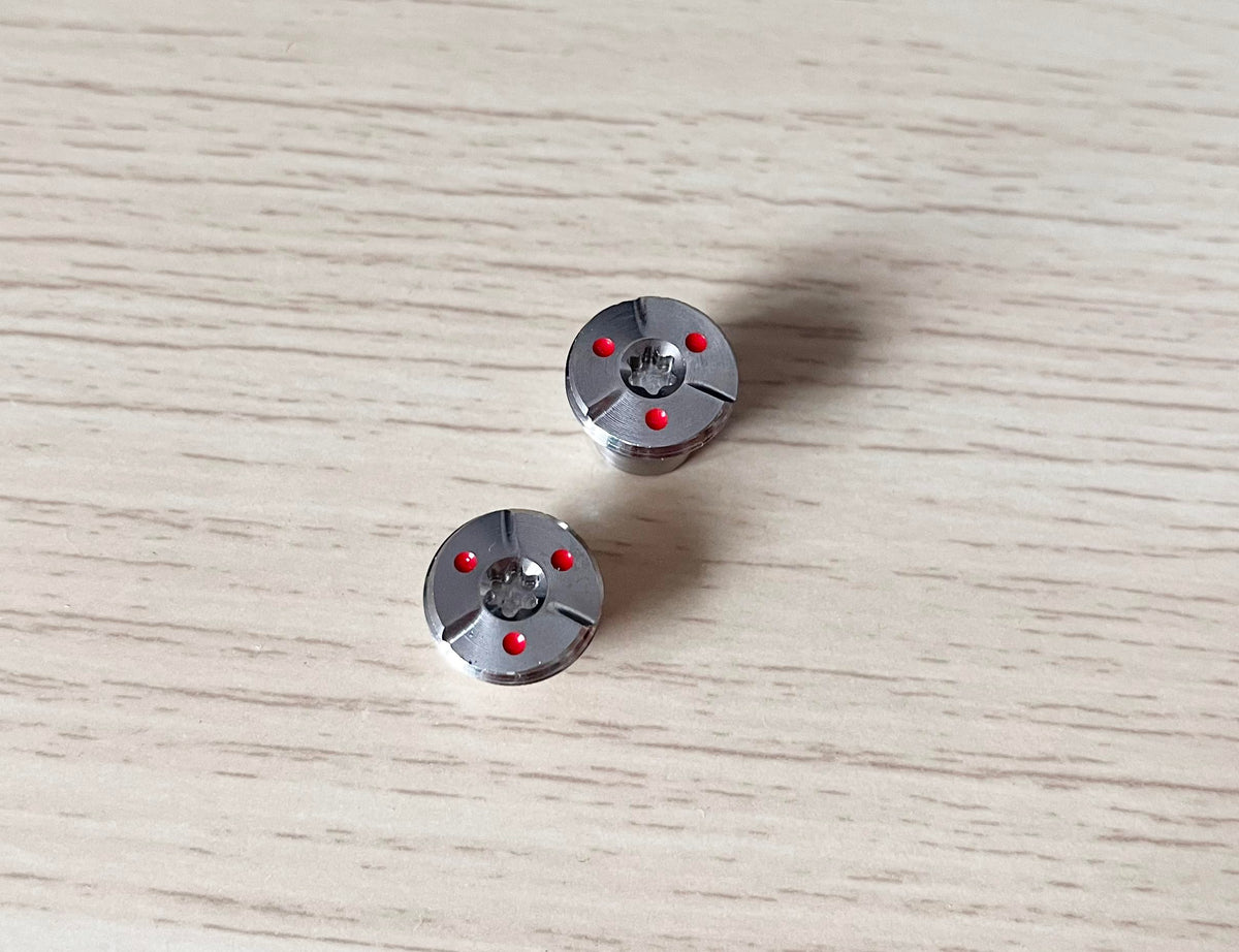 Dree weight screws shown on a golf club for precise adjustments.