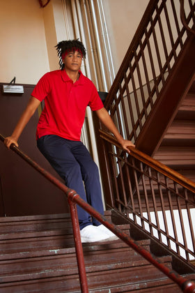 French Toast men's polo red fabric close-up highlighting the moisture-wicking material.
