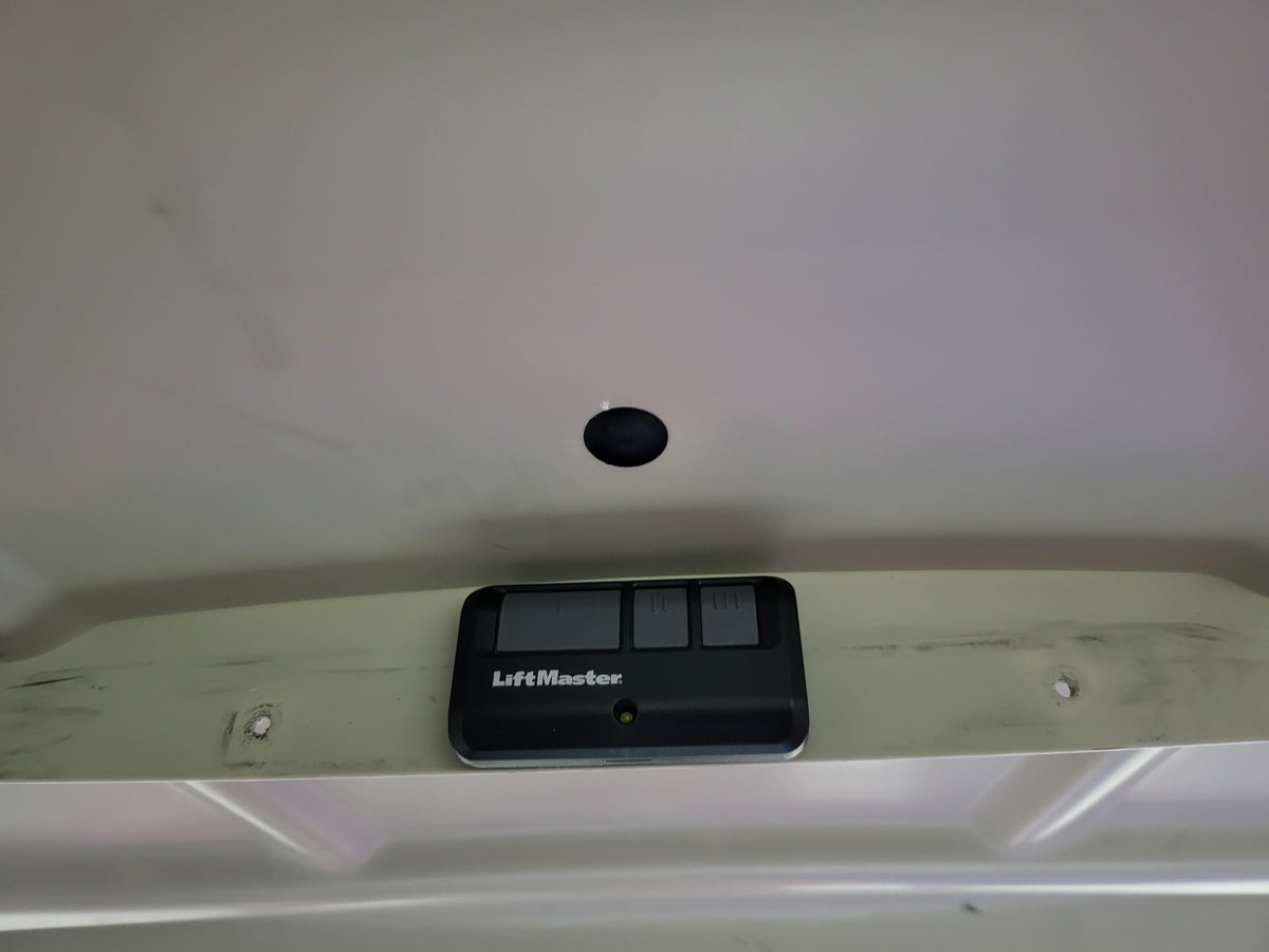 Universal LiftMaster and Chamberlain remote mount on walls.