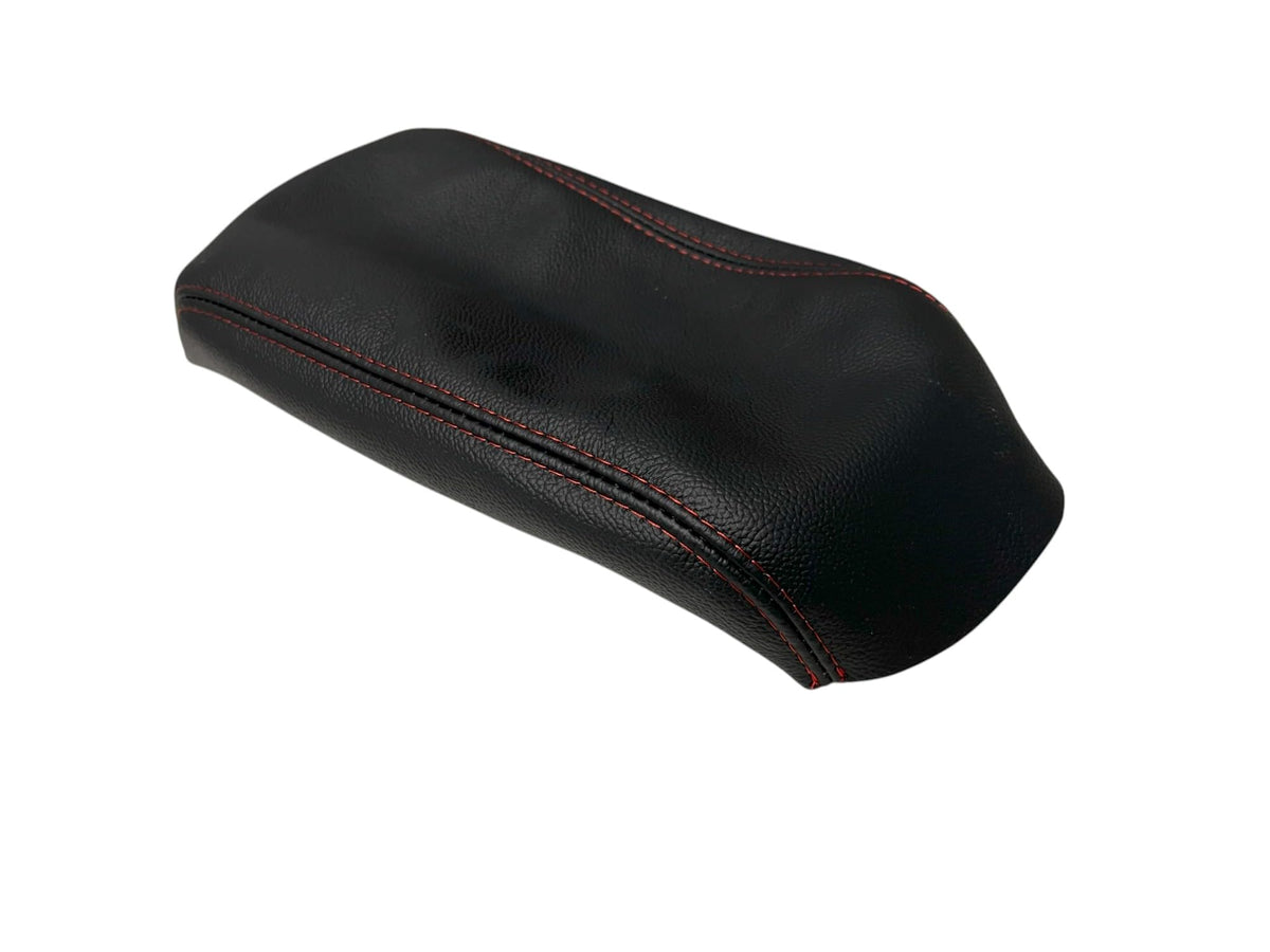 Generic black leather console armrest cover installed on a Forester, enhancing interior aesthetics.