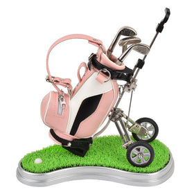 Generic golf pen holder on a workspace with three pens in different colors.