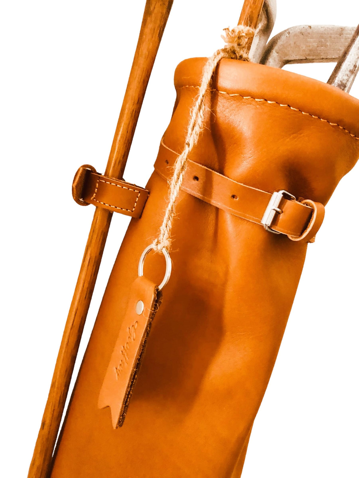 Geoffrey vintage tan leather bag styled for retro golf settings.