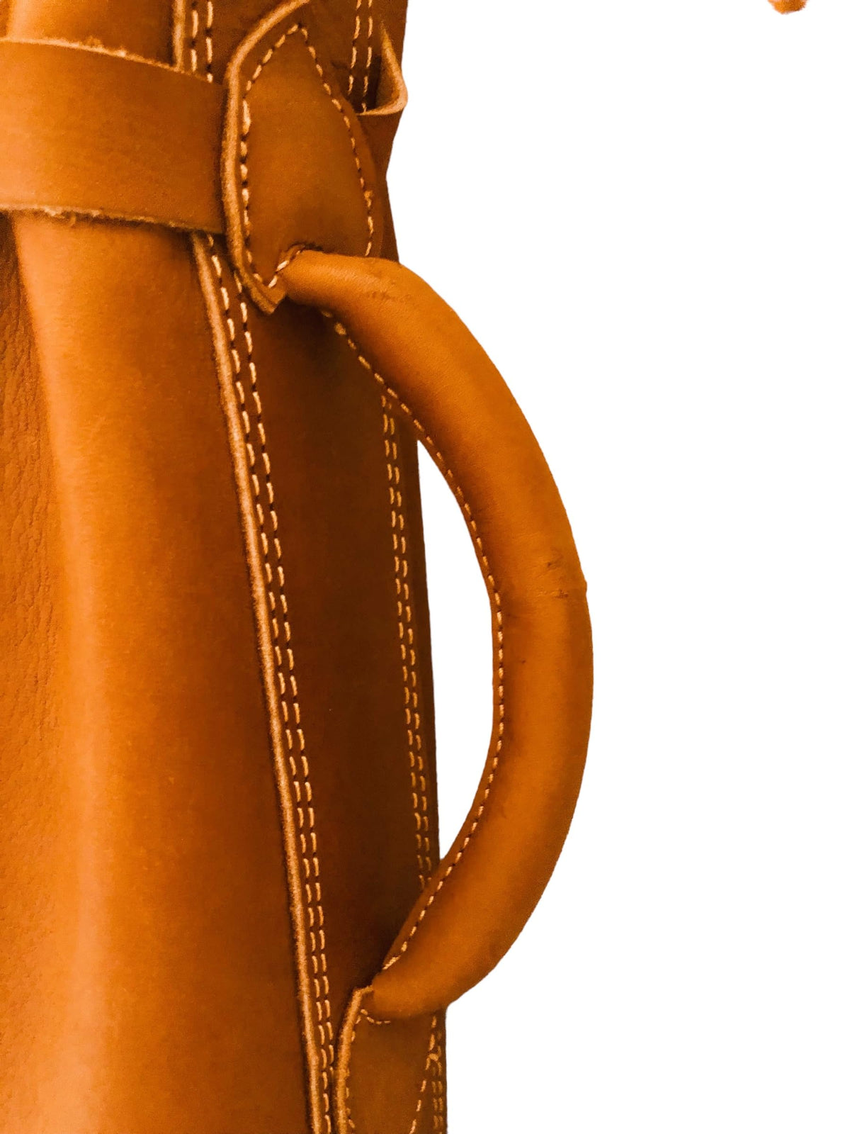 Geoffrey bag features adjustable leather strap for shoulder carry.