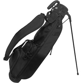 Green Action Sunday Golf Bag with stand deployed for stable setup on uneven turf.