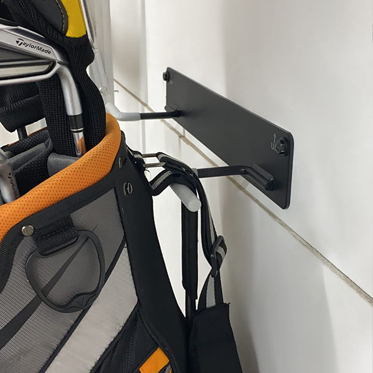 Herbert-fty space-saving design keeps clubs neatly organized on the wall.