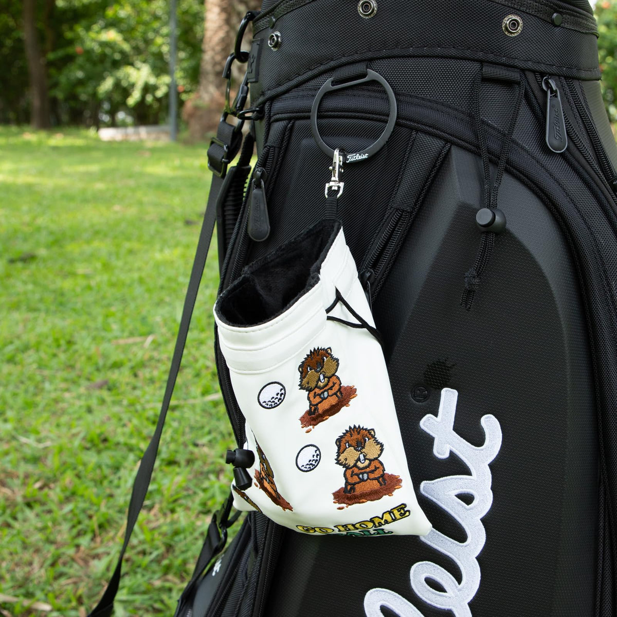 HOOKED ON GOLF drawstring closure secures essentials on the course.