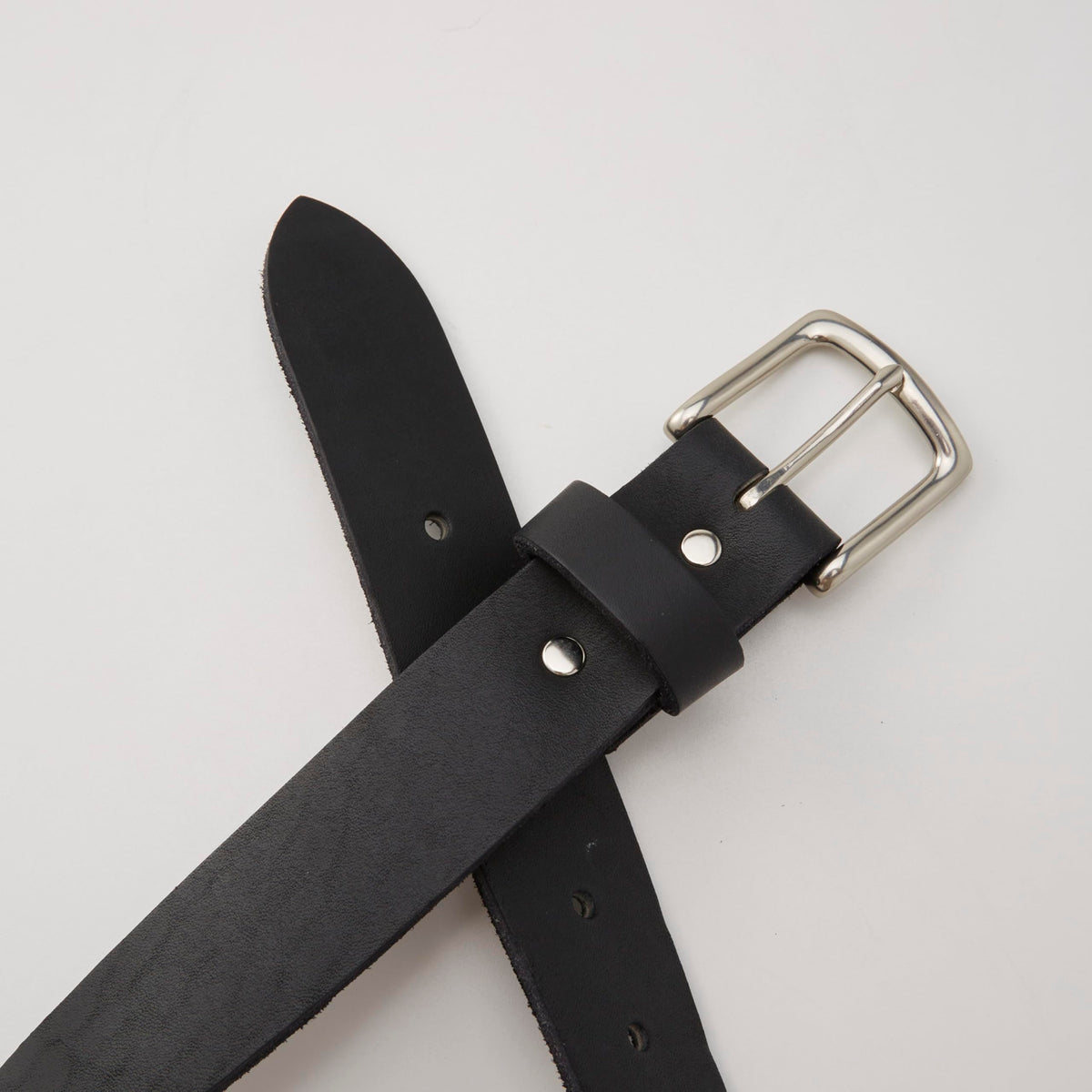 Huckberry 365 belt side view in black, showing full-grain leather and silhouette