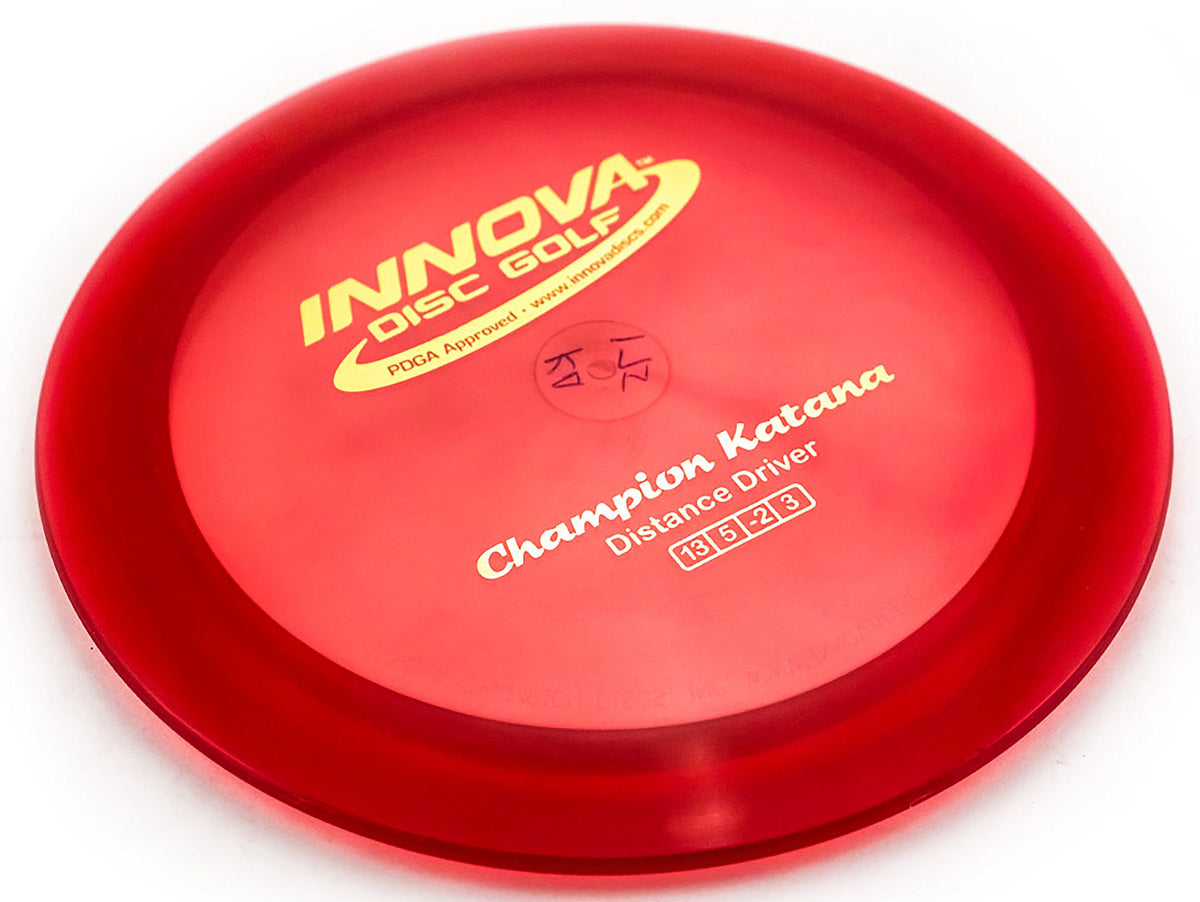 Innova Champion Katana golf disc closeup, highlighting durable Champion plastic for long-distance throws.