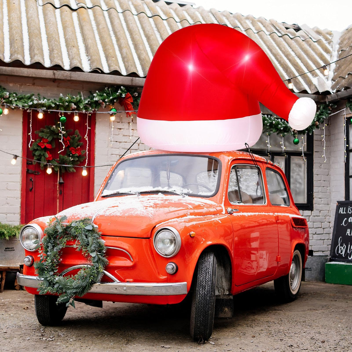 JellyArch inflatable Santa hat on car top with festive curb appeal