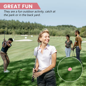 Junkin bright neon pink balls, high visibility on grass.