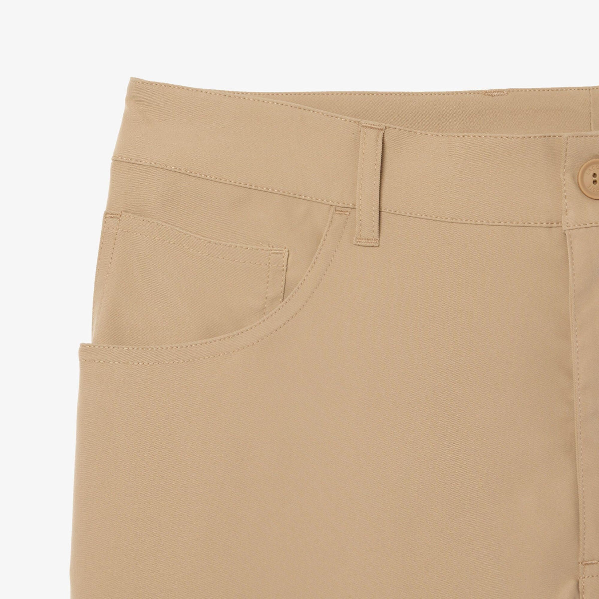 Lacoste fabric close-up shows absorbent stretch twill for freedom of movement.