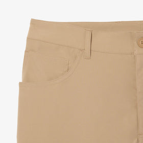 Lacoste fabric close-up shows absorbent stretch twill for freedom of movement.