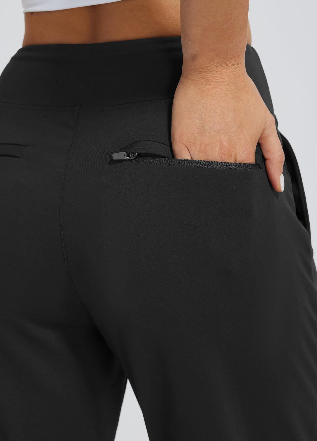 Libin pants showing deep hand pockets and rear zip pockets for secure storage.
