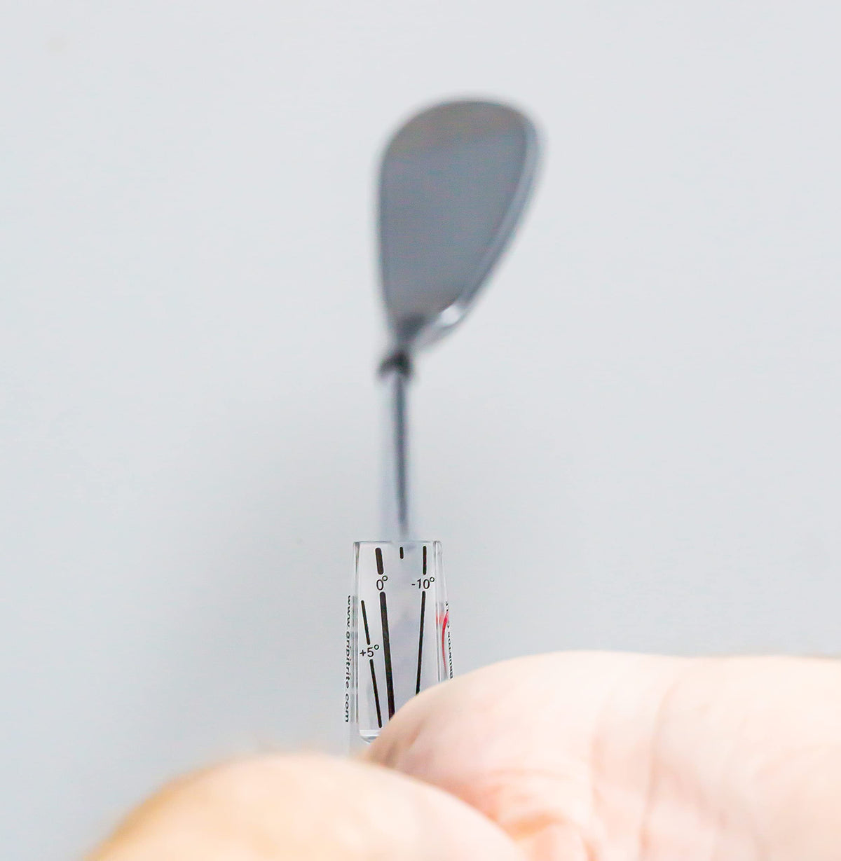 Close-up of hands using GripIt Rite for finger placement.