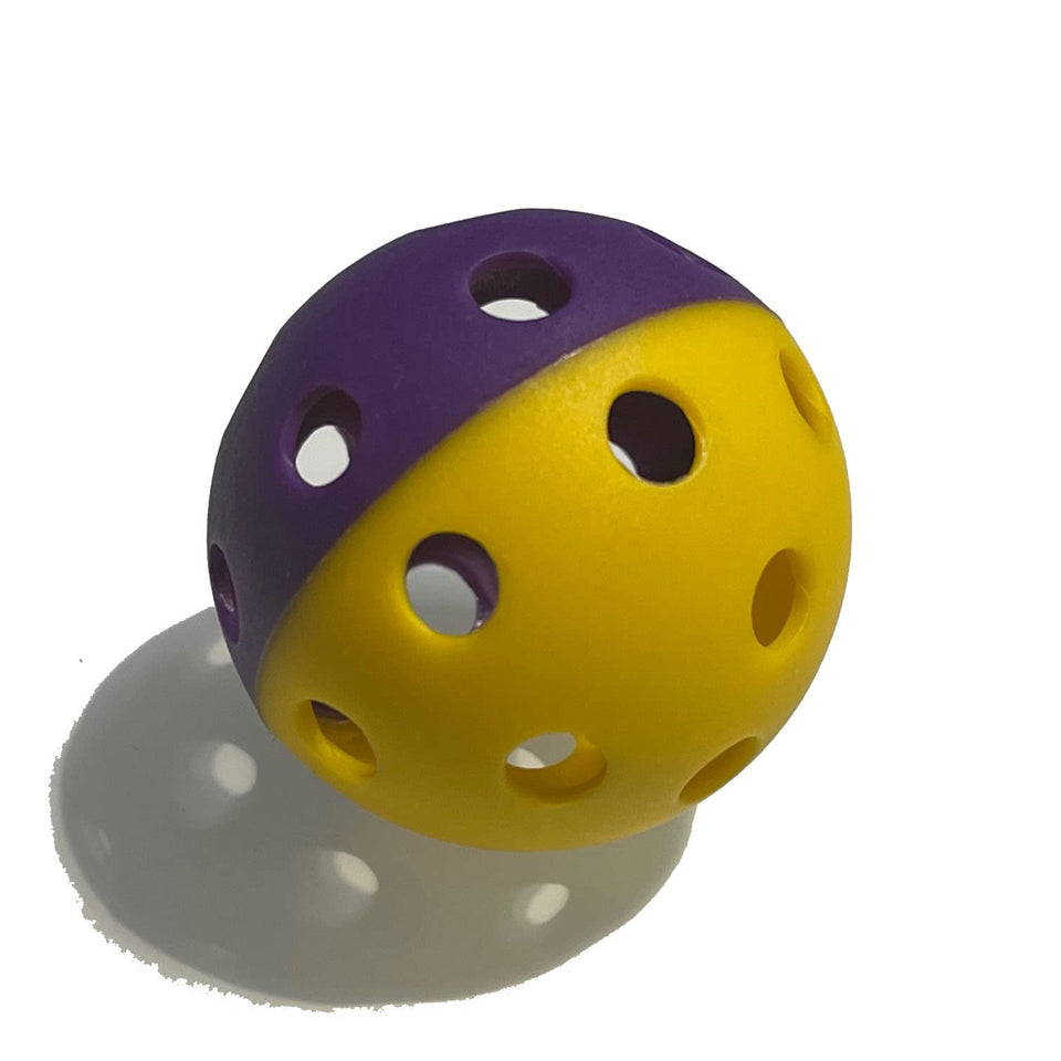 MaxBP golf-size training ball in split purple/yellow for focused drills and rapid repetition