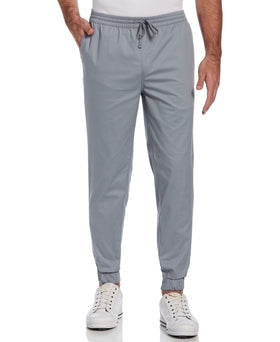 PGA TOUR Men's Eco Dobby Golf Pant Tradewinds front view showing textured fabric and flexible movement