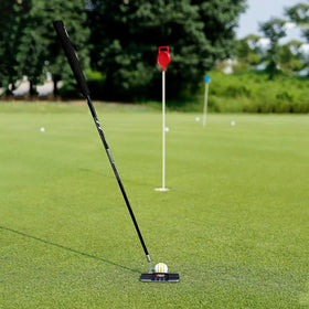 PGM Golf putter stands on grass for hands-free alignment