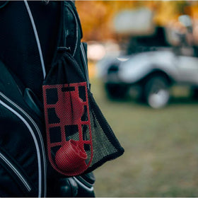Mesh travel case clipped to bag for quick, portable snacks.