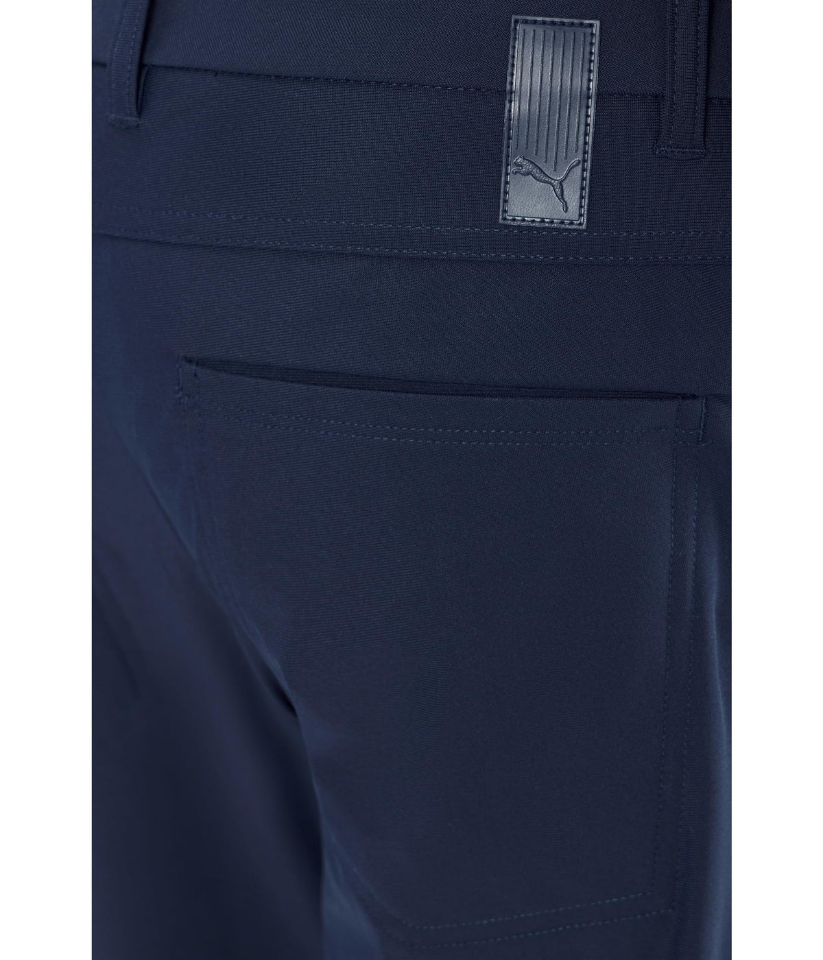 On-model shot of PUMA 101 Premier pants in deep navy for versatile wear.