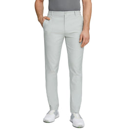 PUMA Dealer Tailored Pant on model during swing showing stretch comfort.