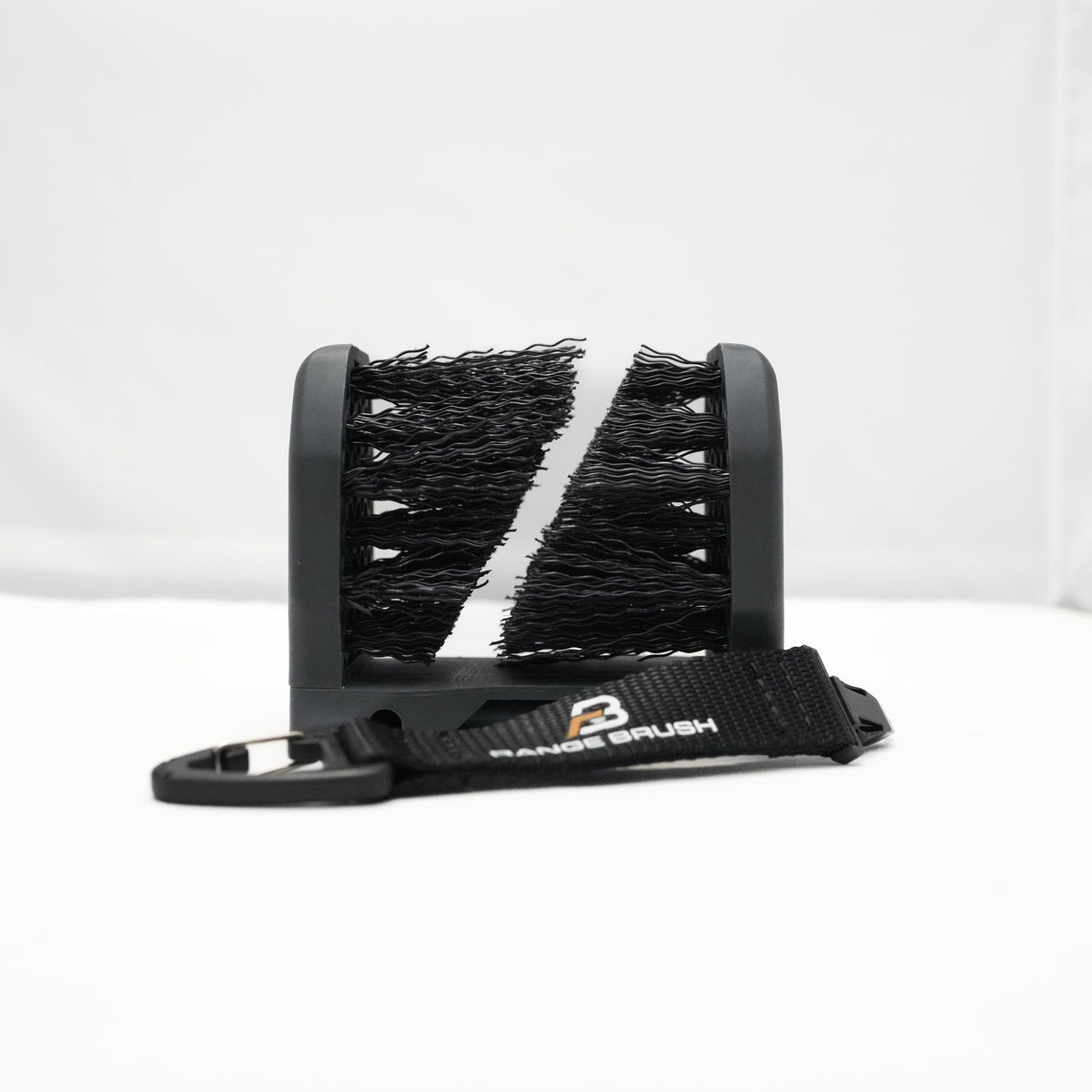 Range Brush fold-out spikes deploy for turf anchoring.