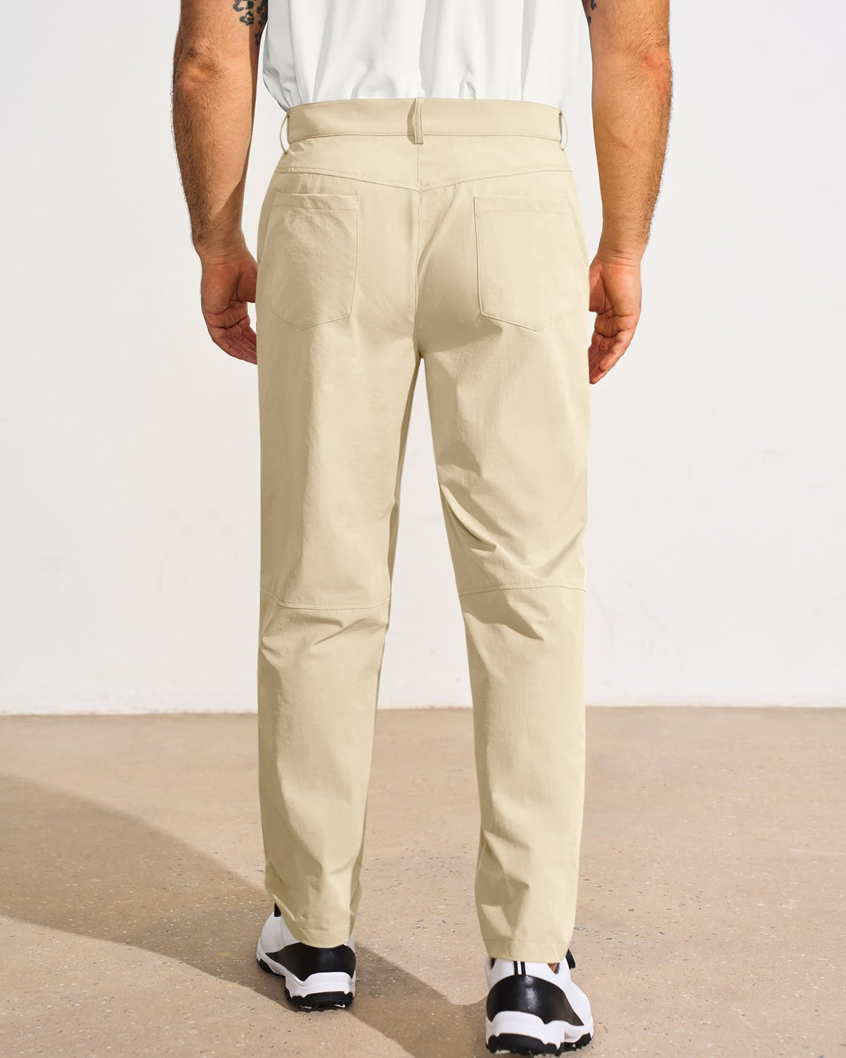 Runcati golf pants pocket detail highlights secure storage on the course.