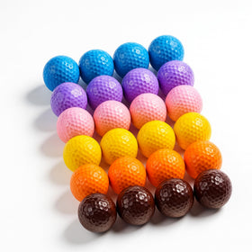 StrikeEdge colored golf balls orange on grass aid quick ball tracking.