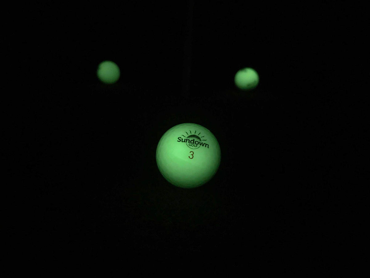 SUNDOWN GOLF glow ball package includes 6-pack and flashlights for nighttime play.