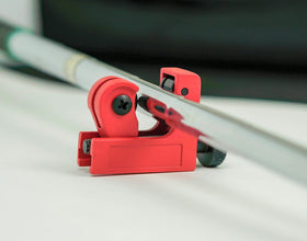 Home workshop setup with shaft cutter and guiding ruler.