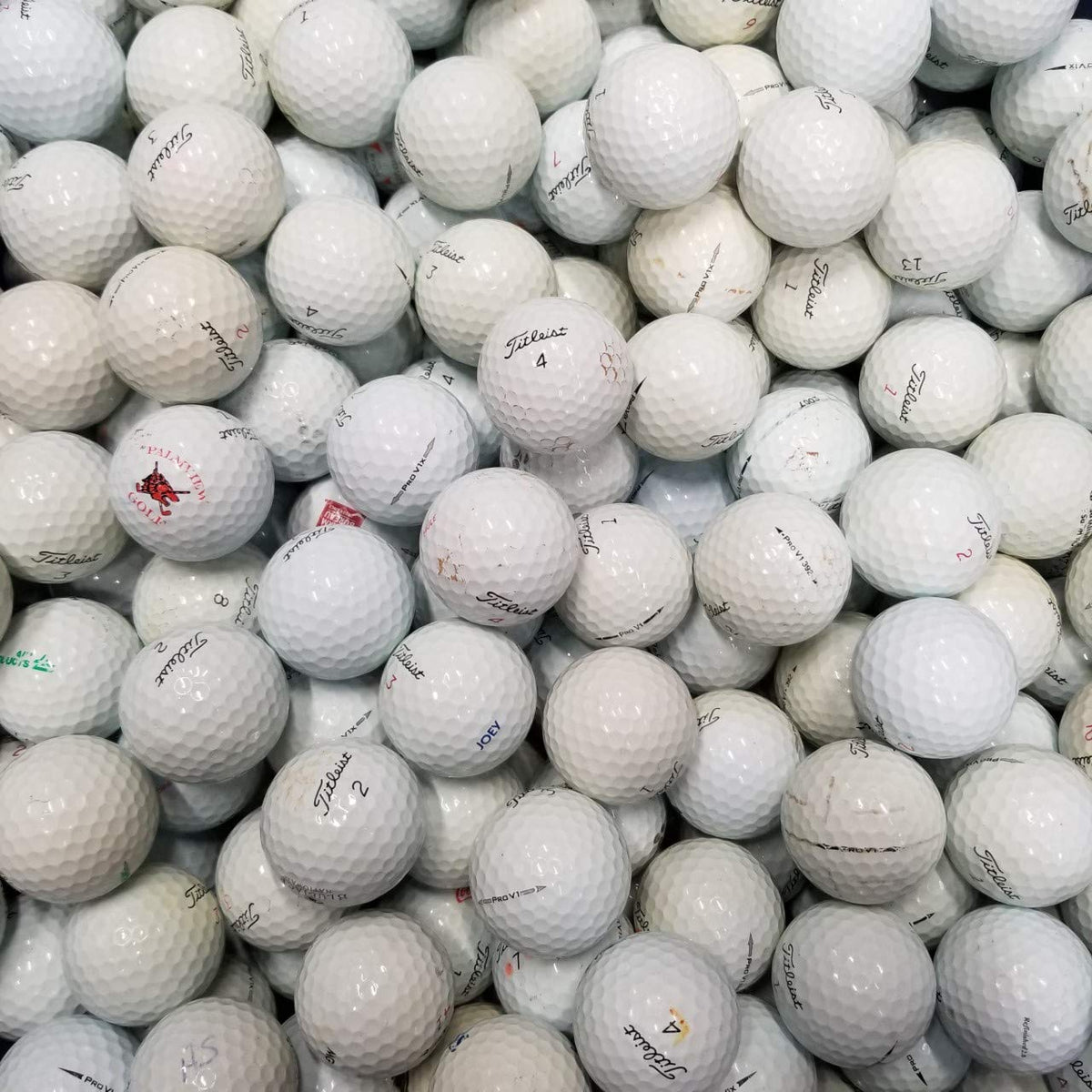 Titleist BC golf balls stored in an onion mesh bag, ideal for travel and practice.