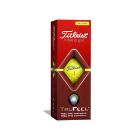 Titleist TruFeel yellow ball resting on the green showing precise control around the hole.