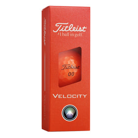 Close-up of Titleist Velocity Orange with dimple design for launch.