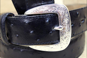 Tony Lama black ostrich dress belt in hand shows everyday versatility.