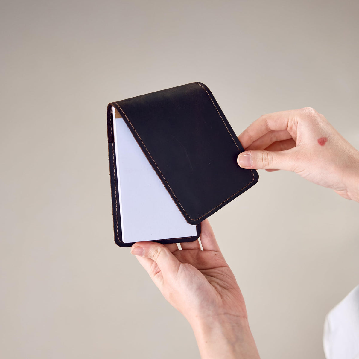 TORAKIP Leather Scorecard Holder in hand, portable golf essential.