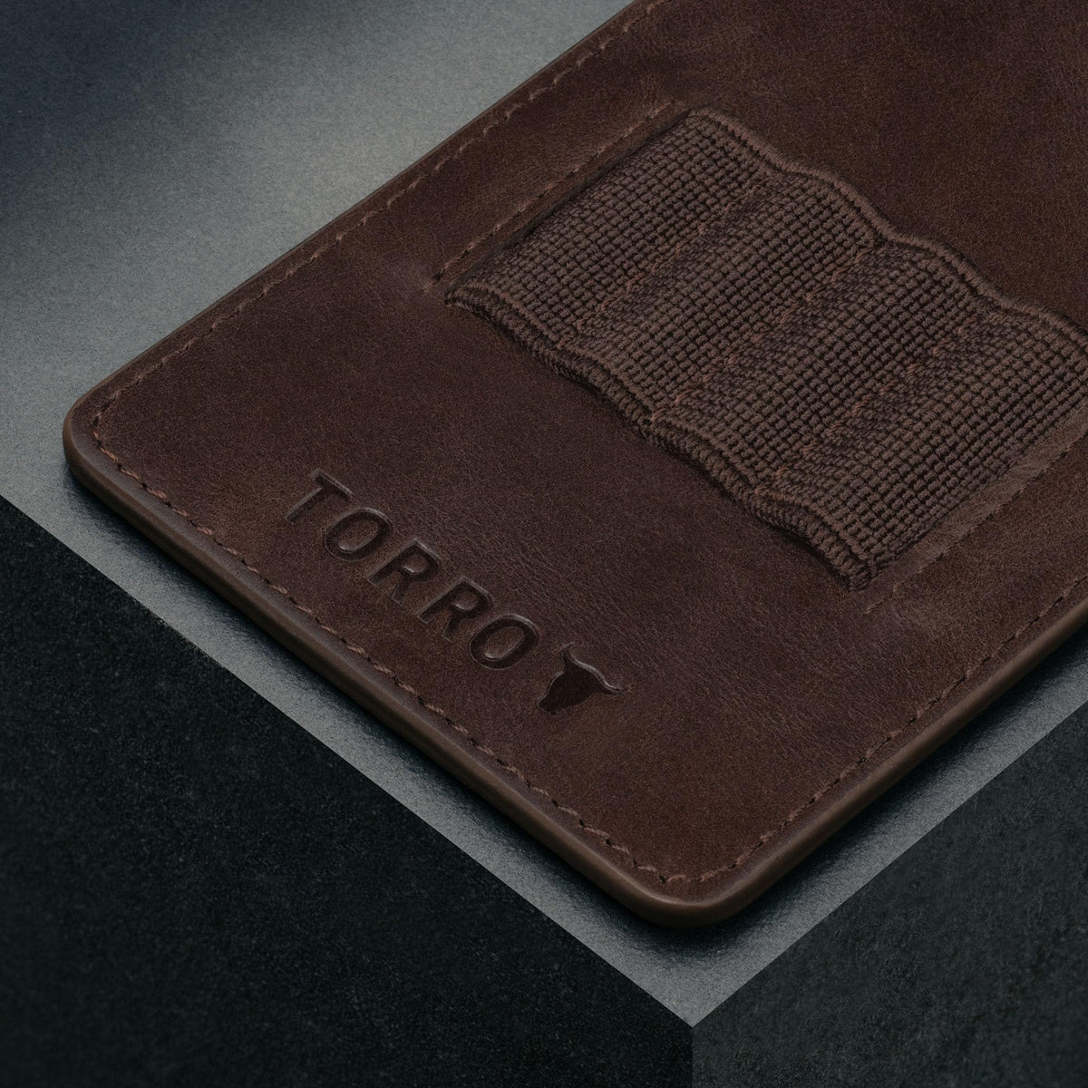 Close-up of TORRO dark brown leather texture showing premium craftsmanship