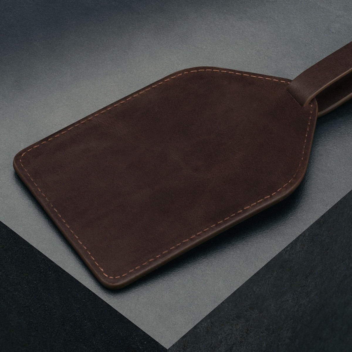 Adjustable leather strap secures the tee holder to your bag